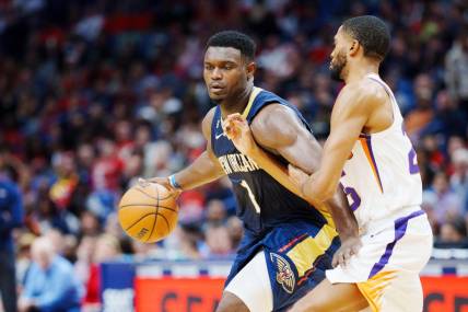 Dec 11, 2022; New Orleans, Louisiana, USA; New Orleans Pelicans forward Zion Williamson (1) fights for position against Phoenix Suns forward Mikal Bridges (25) during the second quarter at Smoothie King Center. Mandatory Credit: Andrew Wevers-USA TODAY Sports