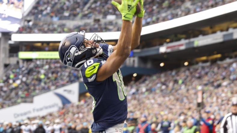 Dec 11, 2022; Seattle, Washington, USA; Seattle Seahawks wide receiver Tyler Lockett (16) catches a touchdown against the Carolina Panthers during the second quarter at Lumen Field. Mandatory Credit: Joe Nicholson-USA TODAY Sports