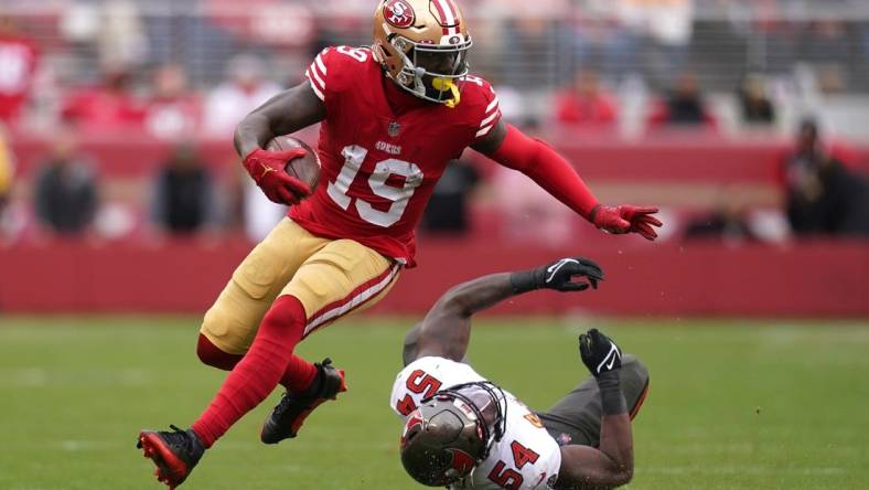 Dec 11, 2022; Santa Clara, California, USA; San Francisco 49ers wide receiver Deebo Samuel (19) runs with the ball in front of Tampa Bay Buccaneers linebacker Lavonte David (54) in the second quarter at Levi's Stadium. Mandatory Credit: Cary Edmondson-USA TODAY Sports