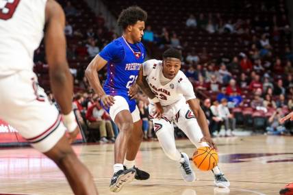 Dec 11, 2022; Columbia, South Carolina, USA; South Carolina Gamecocks forward Gregory Jackson II (23) drives around Presbyterian Blue Hose guard Trevon Reddish-Rhone (23) in the first half at Colonial Life Arena. Mandatory Credit: Jeff Blake-USA TODAY Sports