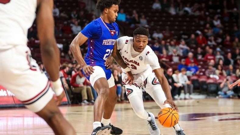 Dec 11, 2022; Columbia, South Carolina, USA; South Carolina Gamecocks forward Gregory Jackson II (23) drives around Presbyterian Blue Hose guard Trevon Reddish-Rhone (23) in the first half at Colonial Life Arena. Mandatory Credit: Jeff Blake-USA TODAY Sports