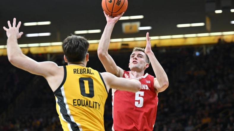 Dec 11, 2022; Iowa City, Iowa, USA; Wisconsin Badgers forward Tyler Wahl (5) shoots the ball over Iowa Hawkeyes forward Filip Rebraca (0) during the first half at Carver-Hawkeye Arena. Mandatory Credit: Jeffrey Becker-USA TODAY Sports