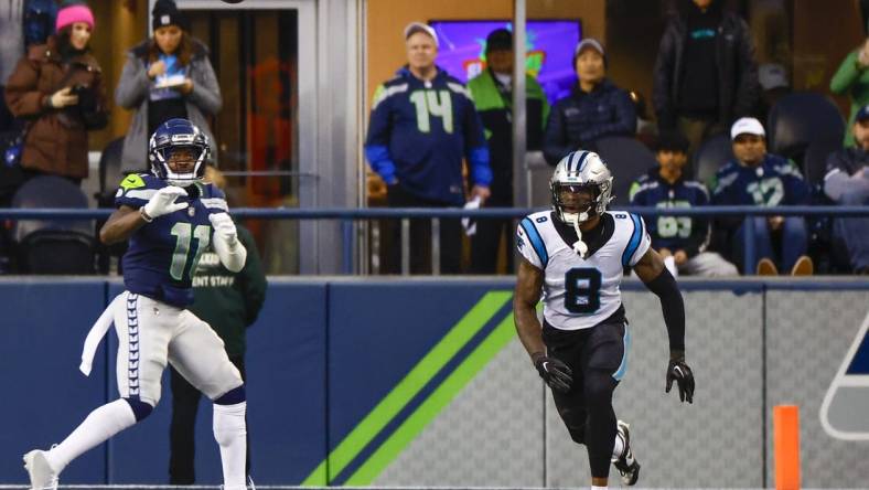 Dec 11, 2022; Seattle, Washington, USA; Seattle Seahawks wide receiver Marquise Goodwin (11) catches a touchdown against Carolina Panthers cornerback Jaycee Horn (8) during the fourth quarter at Lumen Field. Mandatory Credit: Joe Nicholson-USA TODAY Sports