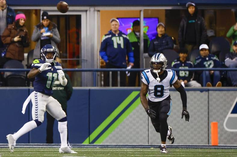Dec 11, 2022; Seattle, Washington, USA; Seattle Seahawks wide receiver Marquise Goodwin (11) catches a touchdown against Carolina Panthers cornerback Jaycee Horn (8) during the fourth quarter at Lumen Field. Mandatory Credit: Joe Nicholson-USA TODAY Sports
