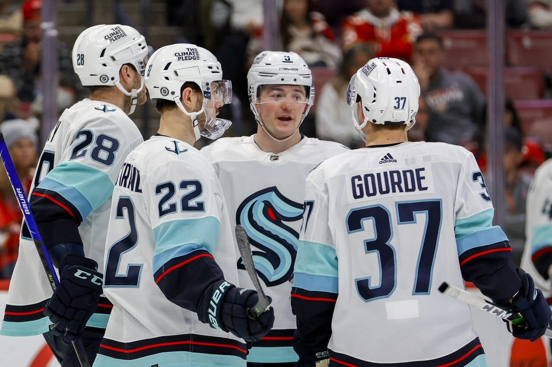 Dec 11, 2022; Sunrise, Florida, USA; Seattle Kraken center Ryan Donato (9) talks to center Yanni Gourde (37) and right wing Oliver Bjorkstrand (22) during the second period against the Florida Panthers at FLA Live Arena. Mandatory Credit: Sam Navarro-USA TODAY Sports