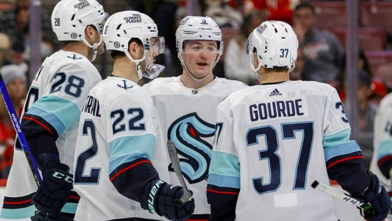 Dec 11, 2022; Sunrise, Florida, USA; Seattle Kraken center Ryan Donato (9) talks to center Yanni Gourde (37) and right wing Oliver Bjorkstrand (22) during the second period against the Florida Panthers at FLA Live Arena. Mandatory Credit: Sam Navarro-USA TODAY Sports