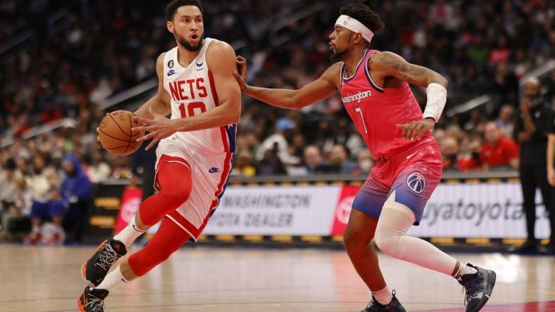 Dec 12, 2022; Washington, District of Columbia, USA; Brooklyn Nets guard Ben Simmons (10) drives to the basket as Washington Wizards guard Jordan Goodwin (7) defends in the second quarter at Capital One Arena. Mandatory Credit: Geoff Burke-USA TODAY Sports