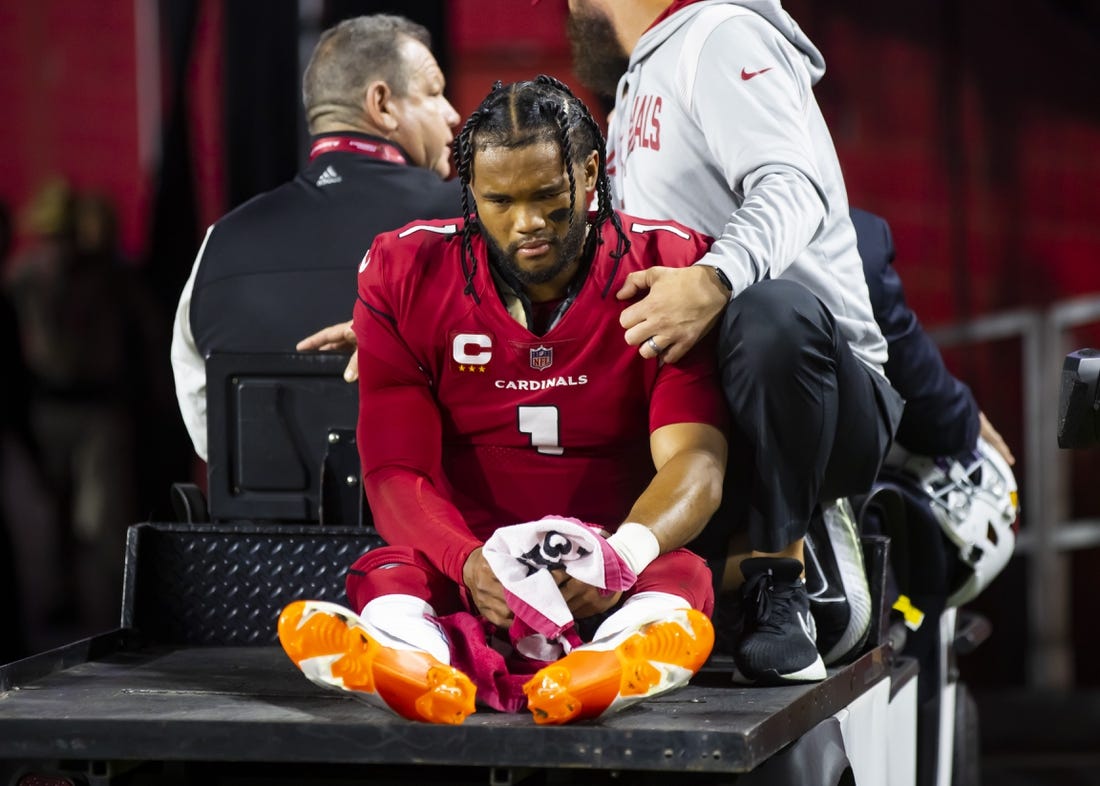 Dec 12, 2022; Glendale, Arizona, USA; Arizona Cardinals quarterback Kyler Murray reacts as he is carted off the field after suffering an injury against the New England Patriots in the first half at State Farm Stadium. Mandatory Credit: Mark J. Rebilas-USA TODAY Sports