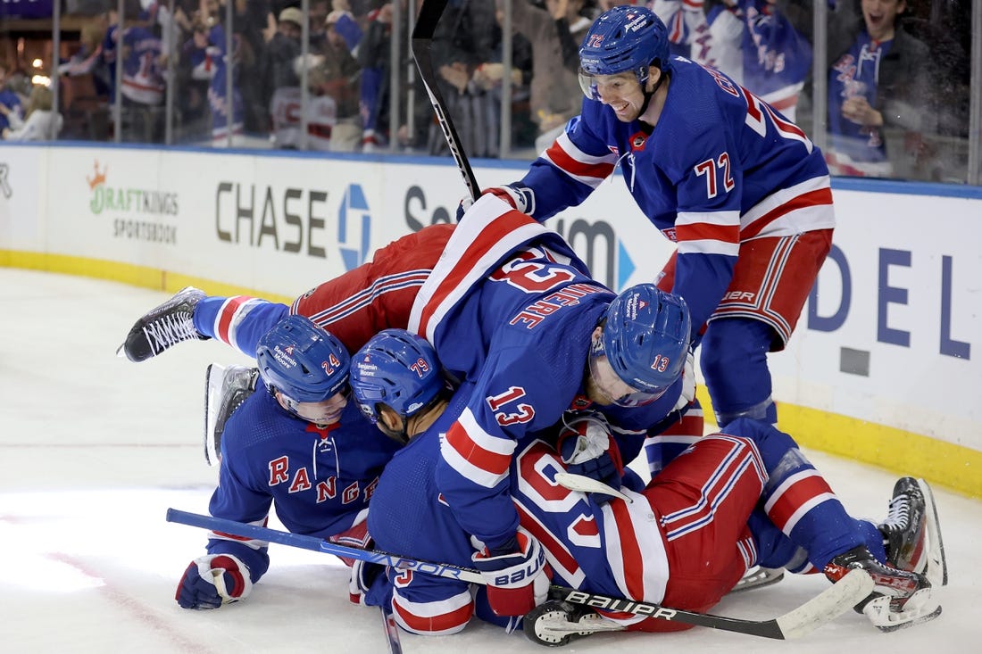 Dec 12, 2022; New York, New York, USA; New York Rangers right wing Kaapo Kakko (24) celebrates his goal against the New Jersey Devils with center Filip Chytil (72) and left wing Alexis Lafreniere (13) and defenseman K'Andre Miller (79) during the second period at Madison Square Garden. Mandatory Credit: Brad Penner-USA TODAY Sports