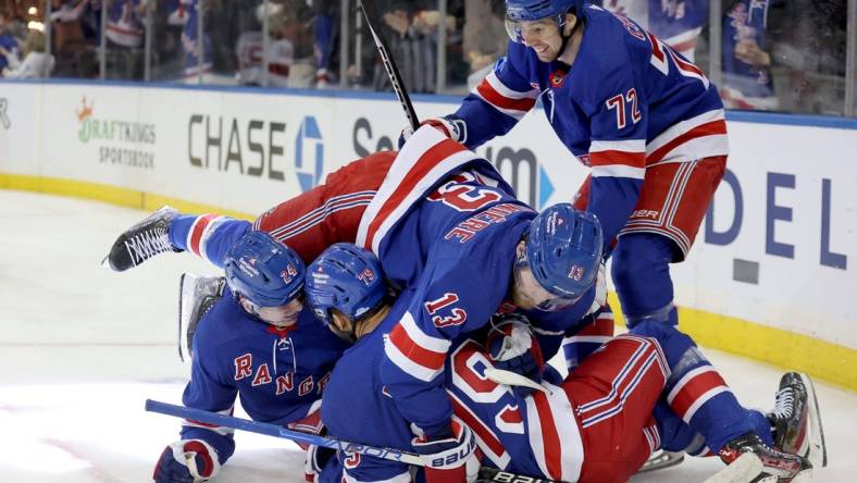 Dec 12, 2022; New York, New York, USA; New York Rangers right wing Kaapo Kakko (24) celebrates his goal against the New Jersey Devils with center Filip Chytil (72) and left wing Alexis Lafreniere (13) and defenseman K'Andre Miller (79) during the second period at Madison Square Garden. Mandatory Credit: Brad Penner-USA TODAY Sports