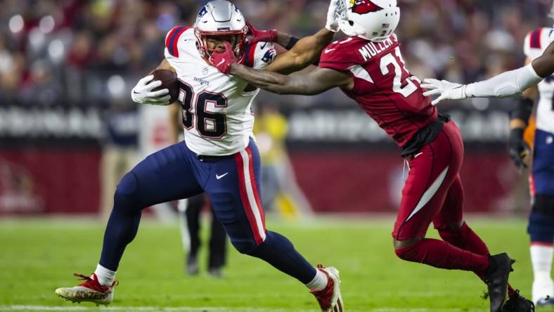 Dec 12, 2022; Glendale, Arizona, USA; New England Patriots running back Kevin Harris (36) is face masked by Arizona Cardinals cornerback Trayvon Mullen (21) in the first half at State Farm Stadium. Mandatory Credit: Mark J. Rebilas-USA TODAY Sports