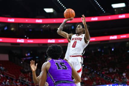 Dec 13, 2022; Raleigh, North Carolina, USA;  North Carolina State Wolfpack guard Terquavion Smith (0) jumps above everyone to score a two pointer during the 1st half against Furman Paladins at PNC Arena. Mandatory Credit: Jaylynn Nash-USA TODAY Sports