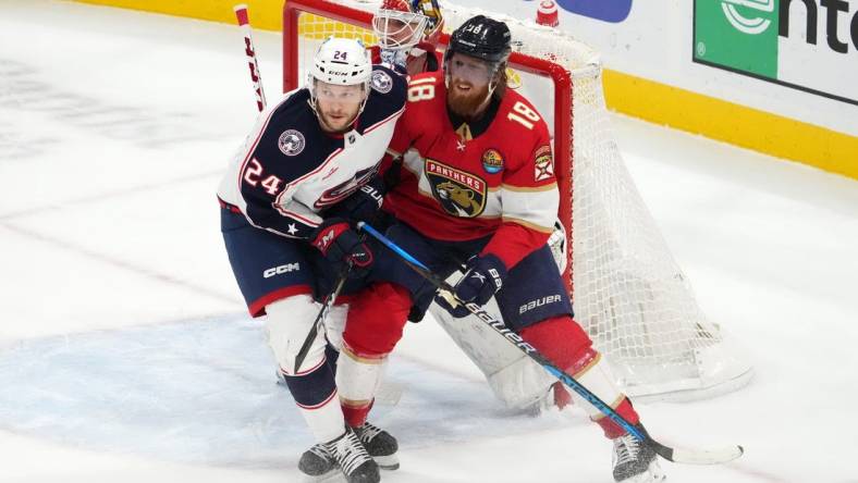 Dec 13, 2022; Sunrise, Florida, USA; Columbus Blue Jackets right wing Mathieu Olivier (24) and Florida Panthers defenseman Marc Staal (18) battle for position in front of goaltender Sergei Bobrovsky (72) during the first period at FLA Live Arena. Mandatory Credit: Jasen Vinlove-USA TODAY Sports