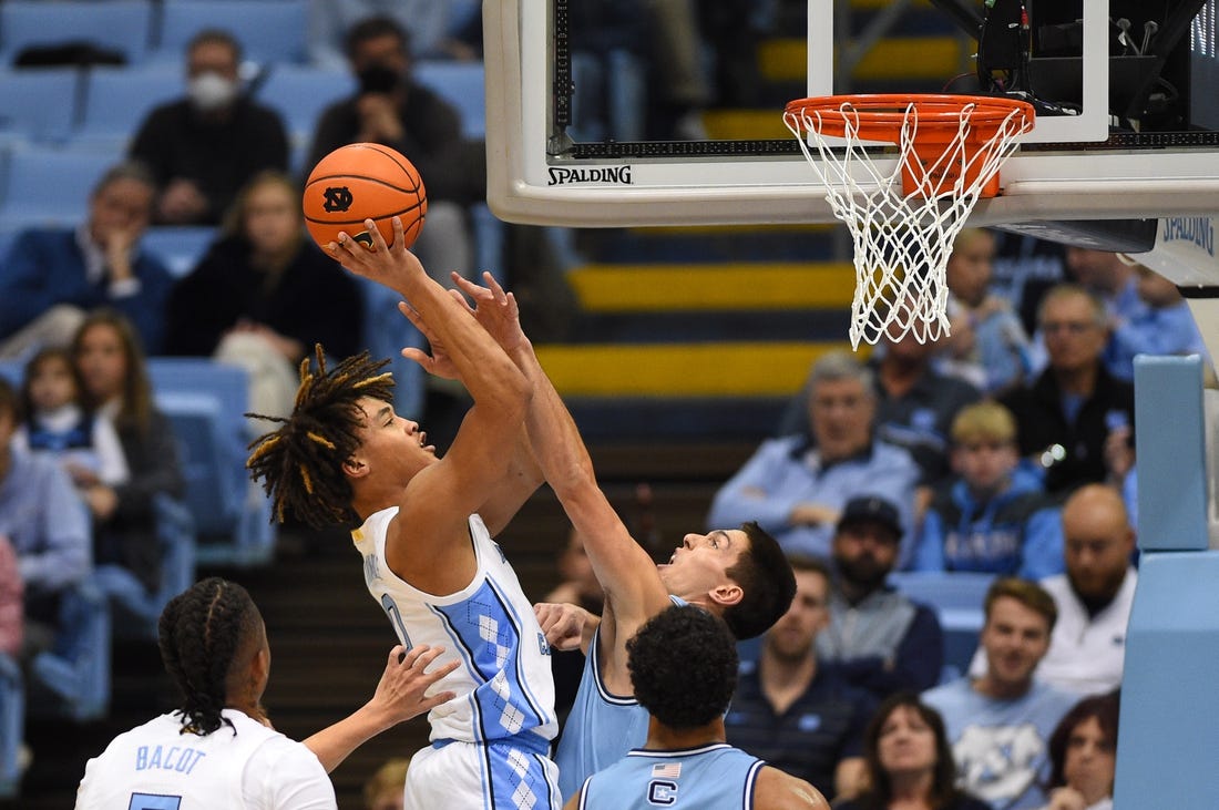 Dec 13, 2022; Chapel Hill, North Carolina, USA;  North Carolina Tar Heels guard Seth Trimble (0) shoots as Citadel Bulldogs guard David Maynard (5) defends in the first half at Dean E. Smith Center. Mandatory Credit: Bob Donnan-USA TODAY Sports