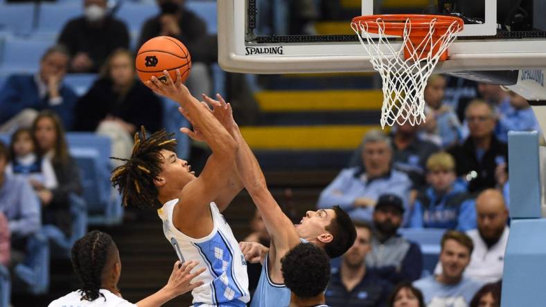 Dec 13, 2022; Chapel Hill, North Carolina, USA;  North Carolina Tar Heels guard Seth Trimble (0) shoots as Citadel Bulldogs guard David Maynard (5) defends in the first half at Dean E. Smith Center. Mandatory Credit: Bob Donnan-USA TODAY Sports