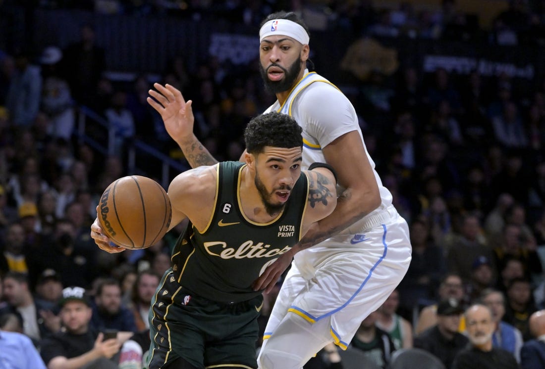 Dec 13, 2022; Los Angeles, California, USA;  Boston Celtics forward Jayson Tatum (0) is defended by Los Angeles Lakers forward Anthony Davis (3) as he moves to the basket in the first half at Crypto.com Arena. Mandatory Credit: Jayne Kamin-Oncea-USA TODAY Sports