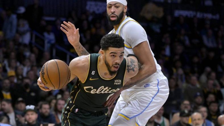 Dec 13, 2022; Los Angeles, California, USA;  Boston Celtics forward Jayson Tatum (0) is defended by Los Angeles Lakers forward Anthony Davis (3) as he moves to the basket in the first half at Crypto.com Arena. Mandatory Credit: Jayne Kamin-Oncea-USA TODAY Sports