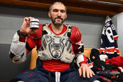 Dec 13, 2022; Chicago, Illinois, USA; Washington Capitals forward Alex Ovechkin (8) poses with the three pucks he scored with against the Chicago Blackhawks to reach the 800 goal career milestone at United Center. Mandatory Credit: Jamie Sabau-USA TODAY Sports