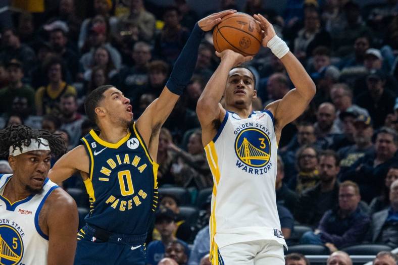 Dec 14, 2022; Indianapolis, Indiana, USA; Indiana Pacers guard Tyrese Haliburton (0) blocks a shot by Golden State Warriors guard Jordan Poole (3) in the first quarter at Gainbridge Fieldhouse. Mandatory Credit: Trevor Ruszkowski-USA TODAY Sports