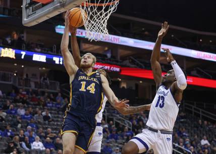 Dec 14, 2022; Newark, New Jersey, USA; Drexel Dragons guard Luke House (14) drives to the basket against Seton Hall Pirates forward KC Ndefo (13) during the first half at Prudential Center. Mandatory Credit: Vincent Carchietta-USA TODAY Sports