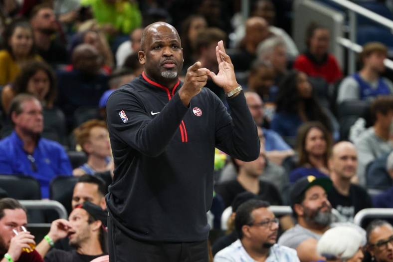 Dec 14, 2022; Orlando, Florida, USA;  Atlanta Hawks head coach Nate McMillan calls a play from the sidelines against the Orlando Magic in the fourth quarter at Amway Center. Mandatory Credit: Nathan Ray Seebeck-USA TODAY Sports