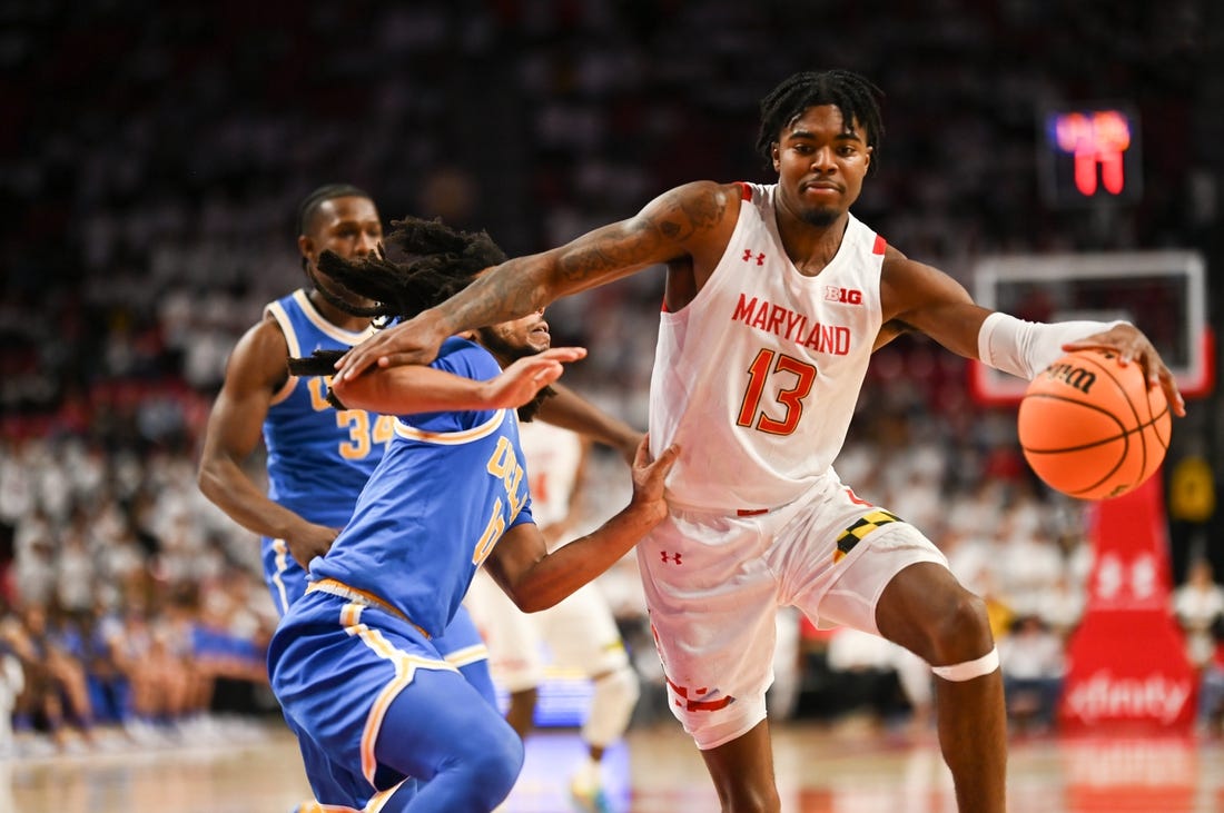 Dec 14, 2022; College Park, Maryland, USA; Maryland Terrapins guard Hakim Hart (13) dribbles by UCLA Bruins guard Tyger Campbell (10) during the second half  at Xfinity Center. Mandatory Credit: Tommy Gilligan-USA TODAY Sports