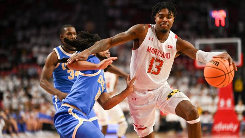 Dec 14, 2022; College Park, Maryland, USA; Maryland Terrapins guard Hakim Hart (13) dribbles by UCLA Bruins guard Tyger Campbell (10) during the second half  at Xfinity Center. Mandatory Credit: Tommy Gilligan-USA TODAY Sports