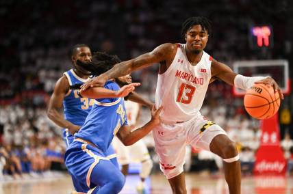 Dec 14, 2022; College Park, Maryland, USA; Maryland Terrapins guard Hakim Hart (13) dribbles by UCLA Bruins guard Tyger Campbell (10) during the second half  at Xfinity Center. Mandatory Credit: Tommy Gilligan-USA TODAY Sports