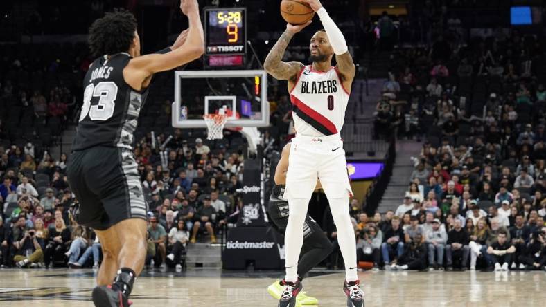 Dec 14, 2022; San Antonio, Texas, USA; Portland Trail Blazers guard Damian Lillard (0) shoots over San Antonio Spurs guard Tre Jones (33) during the second half at AT&T Center. Mandatory Credit: Scott Wachter-USA TODAY Sports