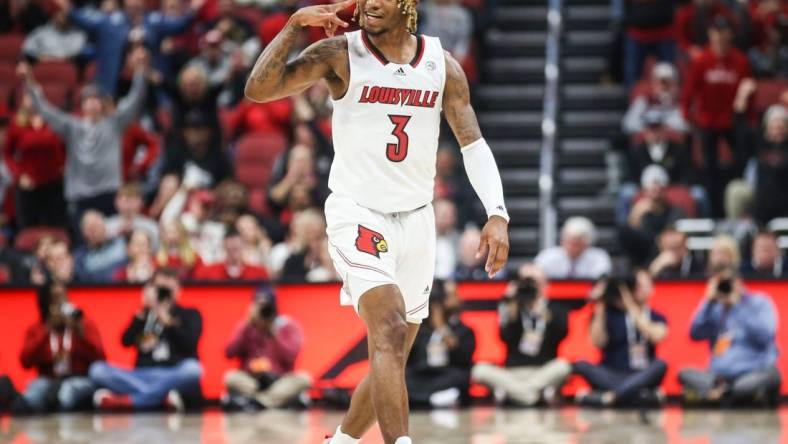 Louisville's El Ellis signals a three while he celebrates after hitting a three-point shot early in first half as the Cards beat WKU 94-83 at the Yum! Center in downtown Louisville Wednesday night. Dec. 14, 2022

Louisville Men Vs Western Kentucky Basketball 2022