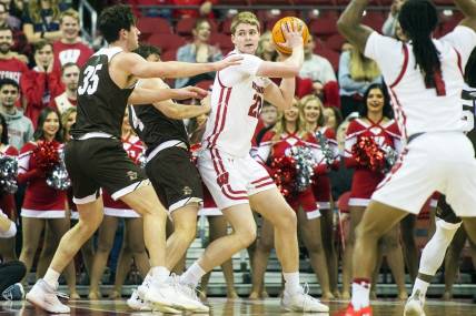 Dec 15, 2022; Madison, Wisconsin, USA;  Wisconsin Badgers forward Steven Crowl (22) looks to pass the ball under coverage by Lehigh Mountain Hawks forward Dominic Parolin (35) and guard Reed Fenton (4) during the first half at the Kohl Center. Mandatory Credit: Kayla Wolf-USA TODAY Sports