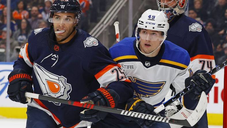 Dec 15, 2022; Edmonton, Alberta, CAN; Edmonton Oilers defensemen Darnell Nurse (25) and St. Louis Blues forward Ivan Barbashev (49) battle for position during the second period at Rogers Place. Mandatory Credit: Perry Nelson-USA TODAY Sports