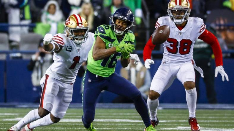 Dec 15, 2022; Seattle, Washington, USA; Seattle Seahawks wide receiver Tyler Lockett (16) drops a pass before being hit by San Francisco 49ers cornerback Jimmie Ward (1) during the fourth quarter at Lumen Field. Mandatory Credit: Joe Nicholson-USA TODAY Sports