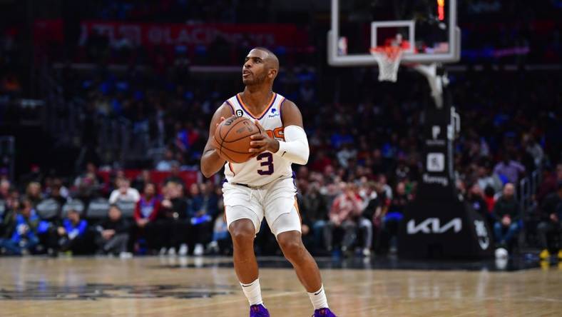 Dec 15, 2022; Los Angeles, California, USA; Phoenix Suns guard Chris Paul (3) shoots against the Los Angeles Clippers during the second half at Crypto.com Arena. Mandatory Credit: Gary A. Vasquez-USA TODAY Sports