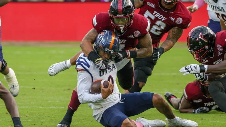 Dec 16, 2022; Orlando, Florida, USA; UTSA Roadrunners quarterback Frank Harris (0) is tackled by Troy Trojans linebacker KJ Robertson (7) during the second quarter at Exploria Stadium. Mandatory Credit: Mike Watters-USA TODAY Sports