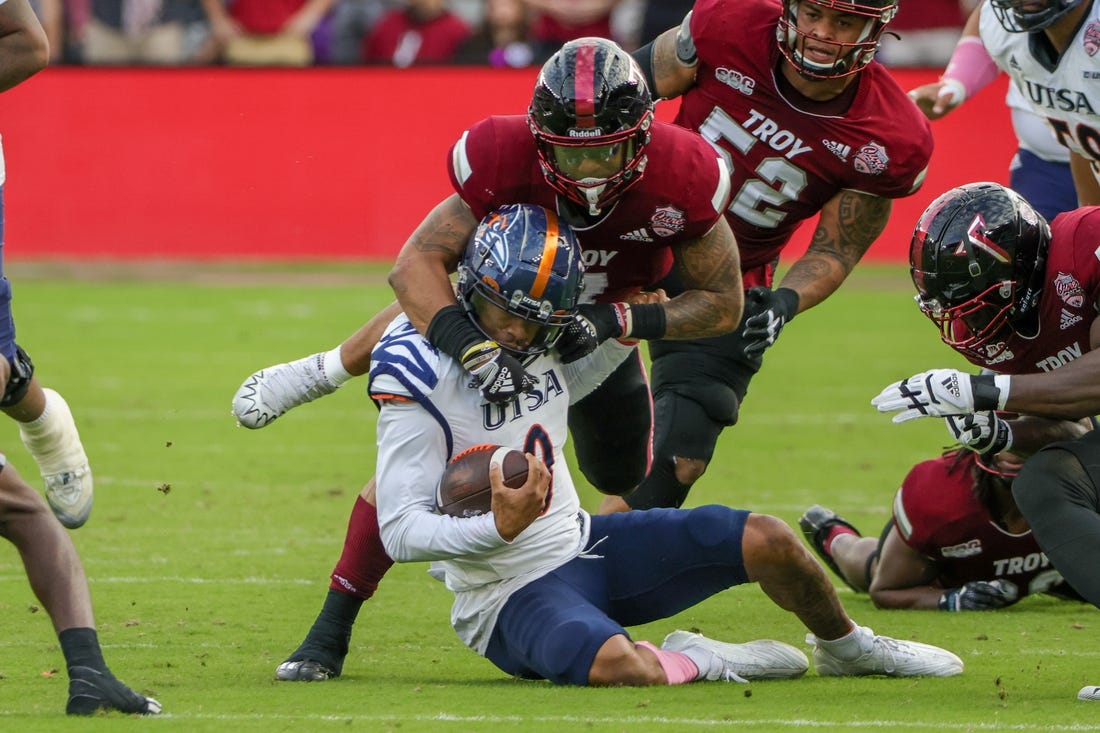 Dec 16, 2022; Orlando, Florida, USA; UTSA Roadrunners quarterback Frank Harris (0) is tackled by Troy Trojans linebacker KJ Robertson (7) during the second quarter at Exploria Stadium. Mandatory Credit: Mike Watters-USA TODAY Sports