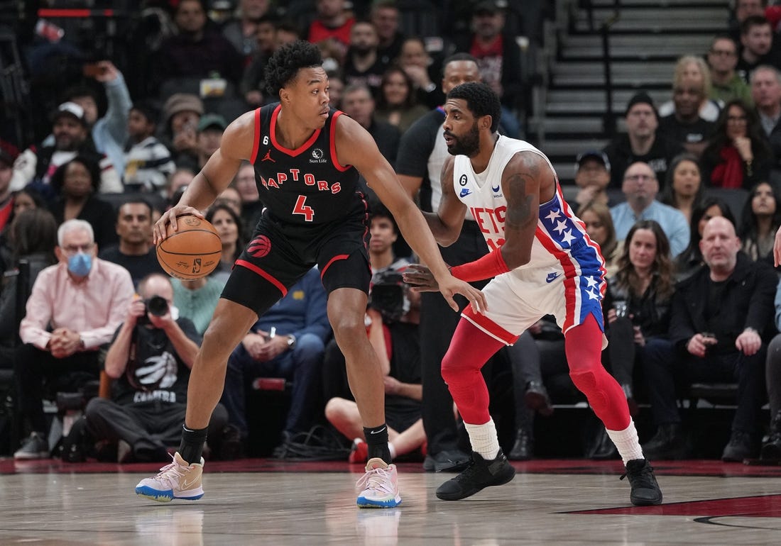 Dec 16, 2022; Toronto, Ontario, CAN; Toronto Raptors forward Scottie Barnes (4) controls the ball as Brooklyn Nets guard Kyrie Irving (11) tries to defend during the first quarter at the Scotiabank Arena. Mandatory Credit: Nick Turchiaro-USA TODAY Sports