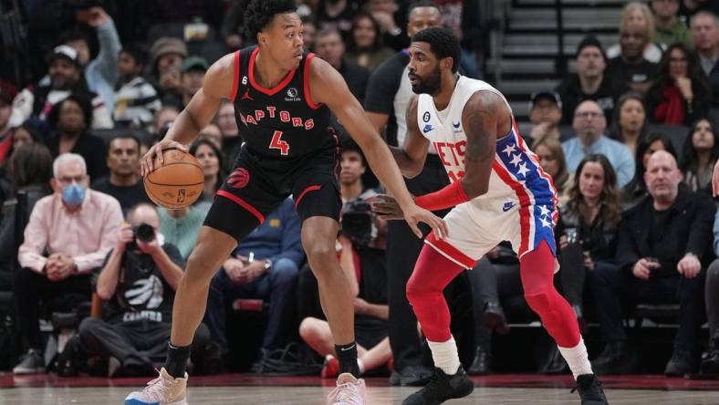 Dec 16, 2022; Toronto, Ontario, CAN; Toronto Raptors forward Scottie Barnes (4) controls the ball as Brooklyn Nets guard Kyrie Irving (11) tries to defend during the first quarter at the Scotiabank Arena. Mandatory Credit: Nick Turchiaro-USA TODAY Sports