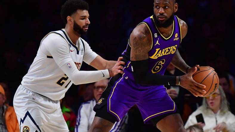 Dec 16, 2022; Los Angeles, California, USA; Los Angeles Lakers forward LeBron James (6) controls the ball against Denver Nuggets guard Jamal Murray (27)  during the first half at Crypto.com Arena. Mandatory Credit: Gary A. Vasquez-USA TODAY Sports