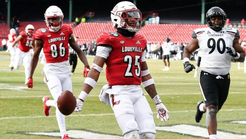 Dec 17, 2022; Boston, MA, USA; Louisville Cardinals running back Jawhar Jordan (25) runs in a touchdown against the Cincinnati Bearcats during the first half at Fenway Park. Mandatory Credit: Eric Canha-USA TODAY Sports