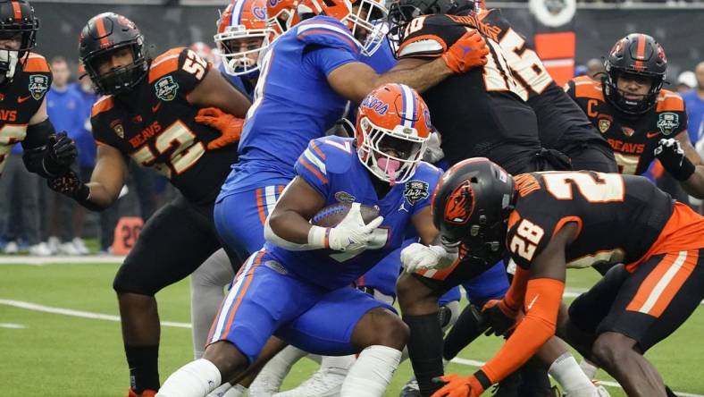 Dec 17, 2022; Las Vegas, NV, USA;  Florida Gators running back Trevor Etienne (7) runs with the ball through the Oregon State Beavers defense during the first half at the Las Vegas Bowl at Allegiant Stadium. Mandatory Credit: Lucas Peltier-USA TODAY Sports