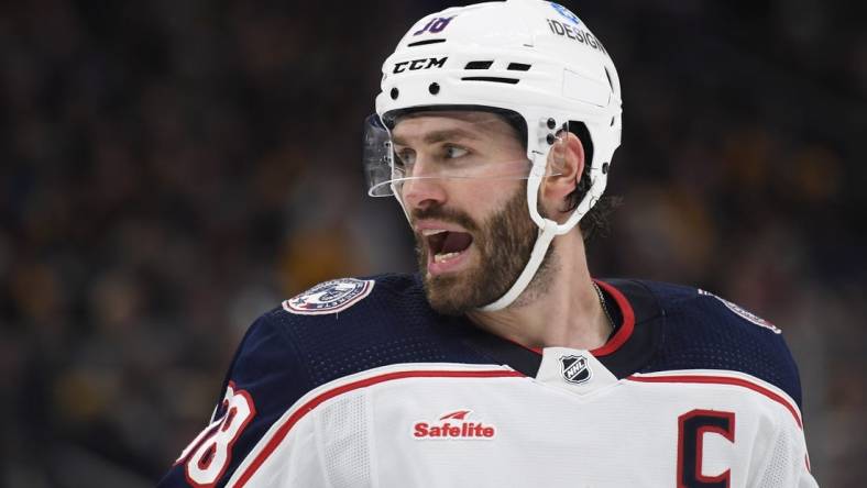 Dec 17, 2022; Boston, Massachusetts, USA;  Columbus Blue Jackets center Boone Jenner (38) has words with one of the Boston Bruins during the second period at TD Garden. Mandatory Credit: Bob DeChiara-USA TODAY Sports