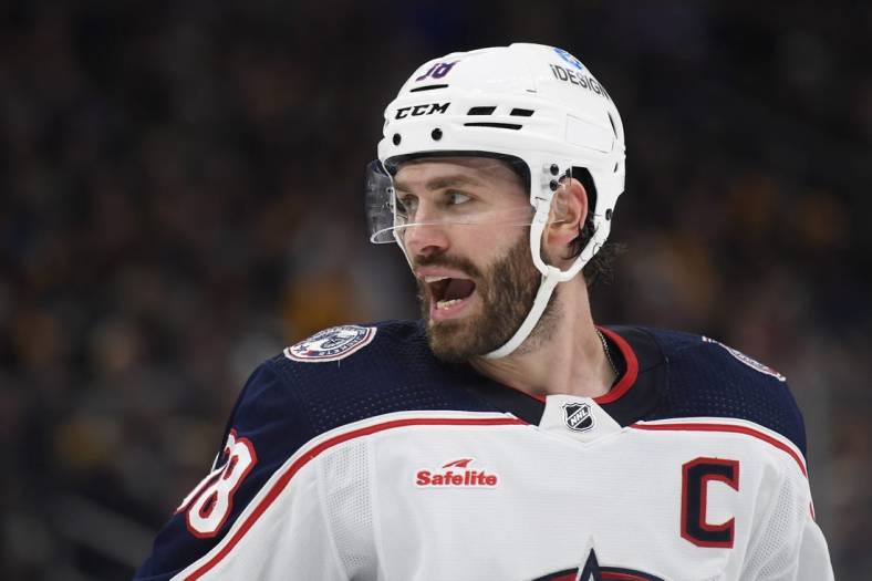 Dec 17, 2022; Boston, Massachusetts, USA;  Columbus Blue Jackets center Boone Jenner (38) has words with one of the Boston Bruins during the second period at TD Garden. Mandatory Credit: Bob DeChiara-USA TODAY Sports