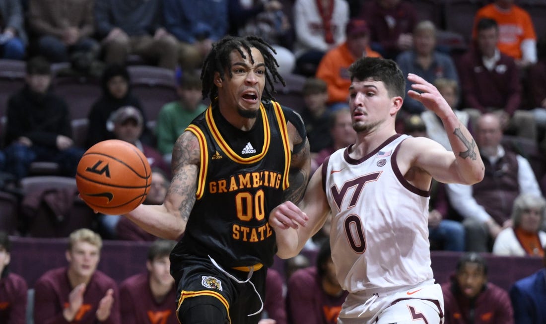 Dec 17, 2022; Blacksburg, Virginia, USA;  Grambling Tigers Virshon Cotton (00) drives around Virginia Tech Hokies guard Hunter Cattoor (0) in the first halfat Cassell Coliseum. Mandatory Credit: Lee Luther Jr.-USA TODAY Sports