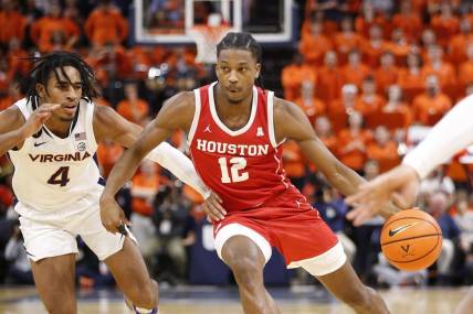 Dec 17, 2022; Charlottesville, Virginia, USA; Houston Cougars guard Tramon Mark (12) dribbles the ball as Virginia Cavaliers guard Armaan Franklin (4) defends during the first half at John Paul Jones Arena. Mandatory Credit: Amber Searls-USA TODAY Sports