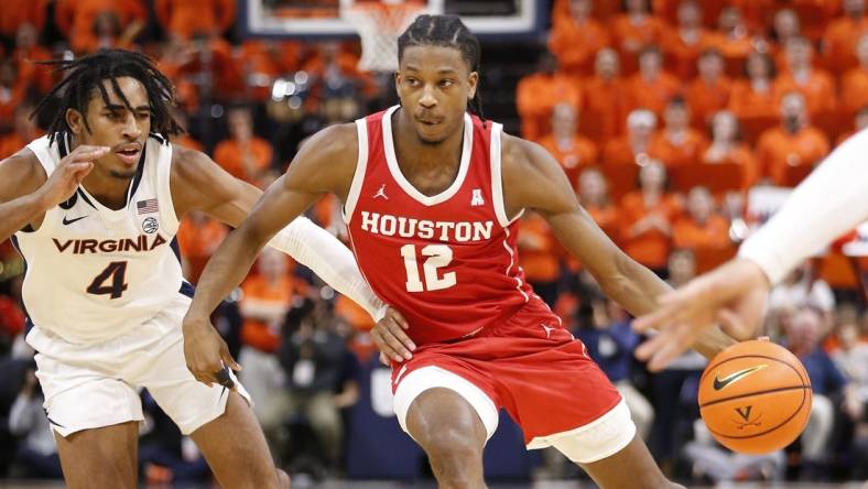 Dec 17, 2022; Charlottesville, Virginia, USA; Houston Cougars guard Tramon Mark (12) dribbles the ball as Virginia Cavaliers guard Armaan Franklin (4) defends during the first half at John Paul Jones Arena. Mandatory Credit: Amber Searls-USA TODAY Sports