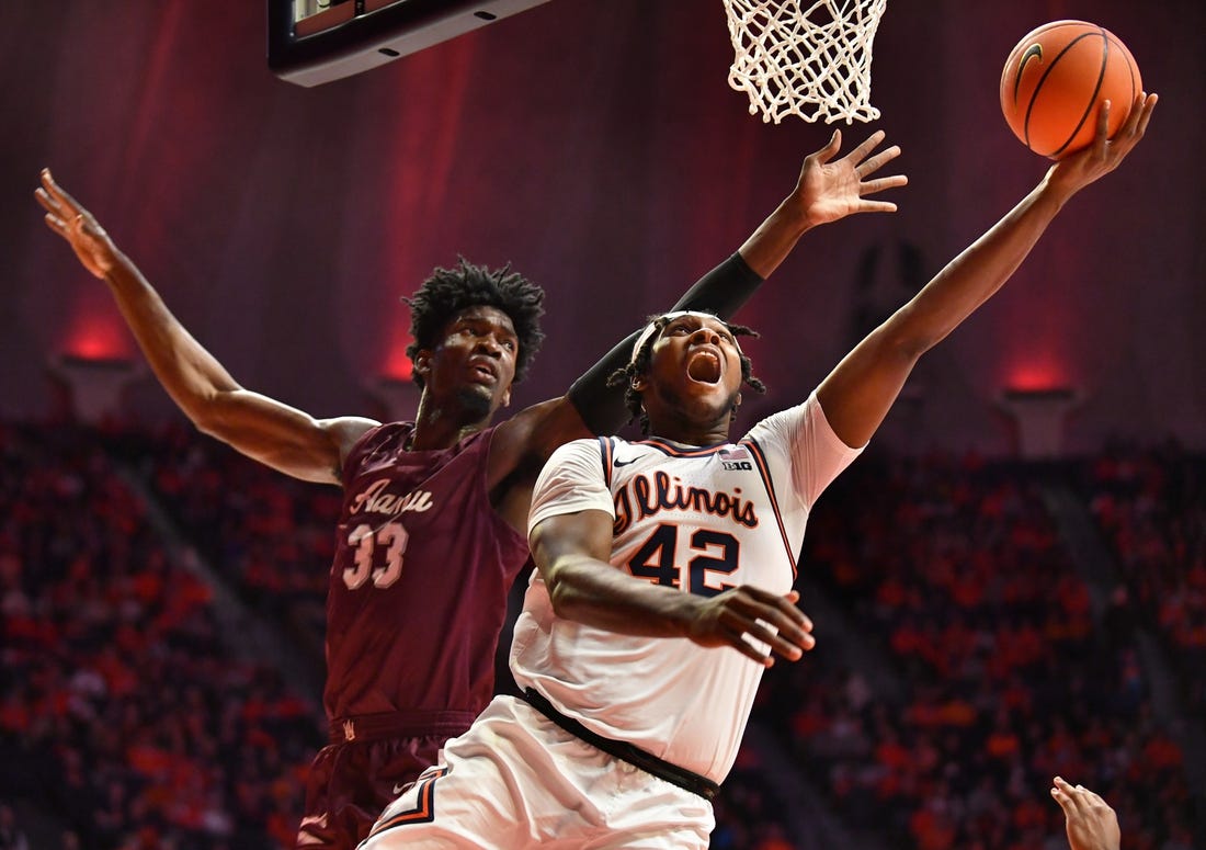 Dec 17, 2022; Champaign, Illinois, USA; Illinois Fighting Illini forward Dain Dainja (42) drives to the basket as Alabama A&M Bulldogs center Olisa Blaise Akonobi (33) defends during the first half at State Farm Center. Mandatory Credit: Ron Johnson-USA TODAY Sports