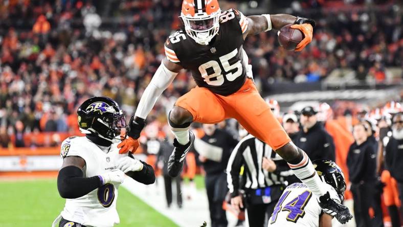 Dec 17, 2022; Cleveland, Ohio, USA; Cleveland Browns tight end David Njoku (85) leaps over Baltimore Ravens cornerback Marlon Humphrey (44) and linebacker Patrick Queen (6) after a catch during the first half at FirstEnergy Stadium. Mandatory Credit: Ken Blaze-USA TODAY Sports