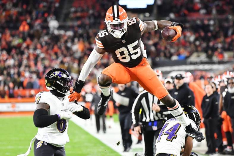 Dec 17, 2022; Cleveland, Ohio, USA; Cleveland Browns tight end David Njoku (85) leaps over Baltimore Ravens cornerback Marlon Humphrey (44) and linebacker Patrick Queen (6) after a catch during the first half at FirstEnergy Stadium. Mandatory Credit: Ken Blaze-USA TODAY Sports