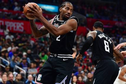 Dec 17, 2022; Los Angeles, California, USA; Los Angeles Clippers forward Kawhi Leonard (2) gets the rebound against the Washington Wizards during the second half at Crypto.com Arena. Mandatory Credit: Gary A. Vasquez-USA TODAY Sports